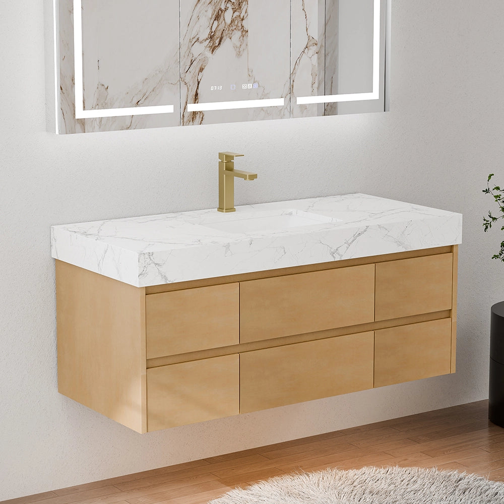 48 Inch Wall Mounted Double Bathroom Vanity in a three-quarter side front view, featuring light maple wood six-drawer floating cabinetry and a crisp white engineered stone countertop with subtle marble veining; accented with a brass gooseneck faucet and a large marble-framed LED backlit mirror, set in a bright modern bathroom with light gray walls, wooden flooring and a white fluffy rug, emphasizing the vanity’s streamlined silhouette and natural wood finish.